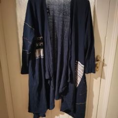 long-sleeved navy garment is an oversized graphic Jacket cardigan.