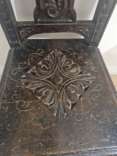 Carved oak antique chair with lion face motif