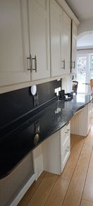 kitchen cabinets and black marble countertop