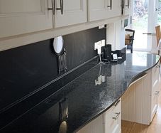 kitchen cabinets and black marble countertop
