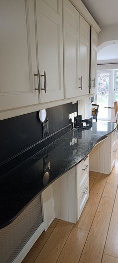 kitchen cabinets and black marble countertop