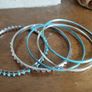 Charming bracelets in silver and blue tones. Image 5