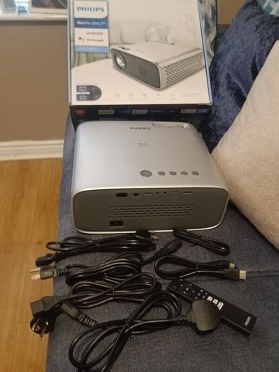 philips neopix ultra 2tv+ home projector and height adjustable stand, built in speakers and android TV with play store stand comes with power point bracket on it as seen in pictures also remote and phone holder