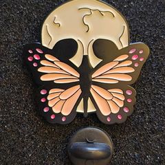 Skull/butterfly , pin back badge.