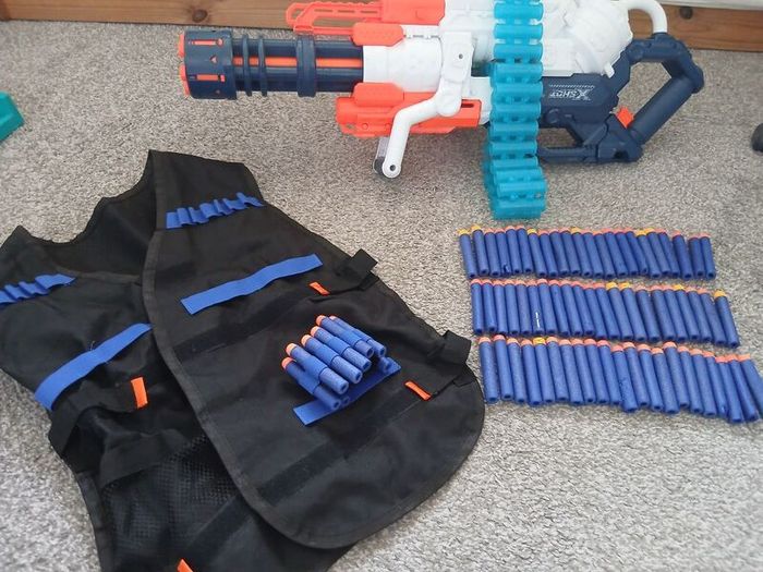Nerf Gun extra large with bullets and gun vest to hold bullets.