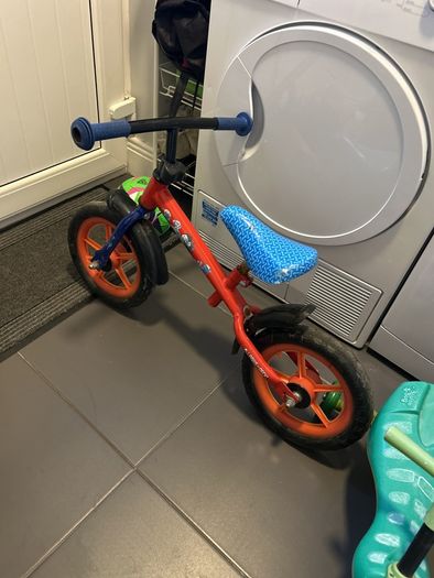 Two toddler bikes and a balance bike