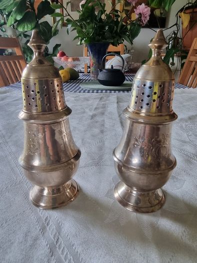 A pair of silver-plated salt shakers