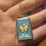 White Butterfly Necklace in Blue Background and Golden Frame Image 4