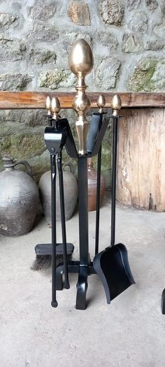 Antique Fire dogs and 4 piece fire set solid brass tops and steel
