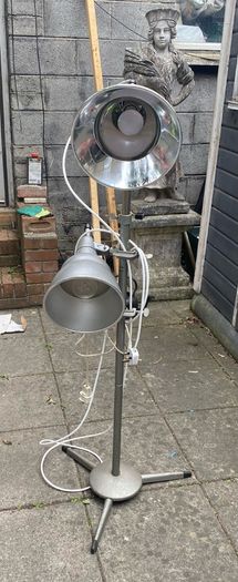 floor lamp This mid-century vintage industrial  floor lamp features twin adjustable reflectors (one fixed pole mount and one clamp-on mount).