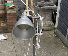 floor lamp This mid-century vintage industrial  floor lamp features twin adjustable reflectors (one fixed pole mount and one clamp-on mount).