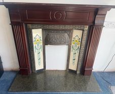 Traditional timber fireplace surround with cast iron insert, decorative tiled side panels and marble-effect hearth, all included. - Moate