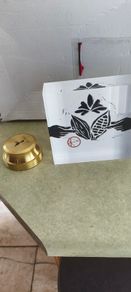 2 Papper Weight , Brass Papper Weight marked ISLAND 12.00 euro. Cleare Risen Tile Papper Weight.with black velvet on the back.10.00 euro.