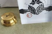 2 Papper Weight , Brass Papper Weight marked ISLAND 12.00 euro. Cleare Risen Tile Papper Weight.with black velvet on the back.10.00 euro.