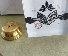 2 Papper Weight , Brass Papper Weight marked ISLAND 12.00 euro. Cleare Risen Tile Papper Weight.with black velvet on the back.10.00 euro.