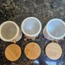 white ceramic tea, coffee, and sugar storage canisters accented with embossed daisy patterns and rustic twine bows. Image 2