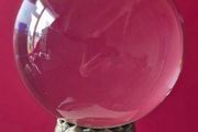 Crystal glass ball on metal lotus flower base.