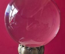 Crystal glass ball on metal lotus flower base.