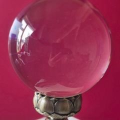 Crystal glass ball on metal lotus flower base.