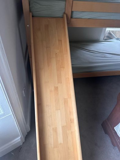 Bunk bed with attached slide and mattresses
