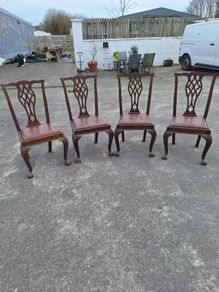 A set of four pierced Chippendale style chairs