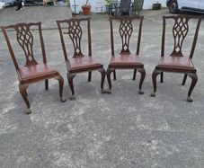 A set of four pierced Chippendale style chairs