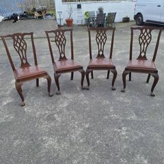 A set of four pierced Chippendale style chairs