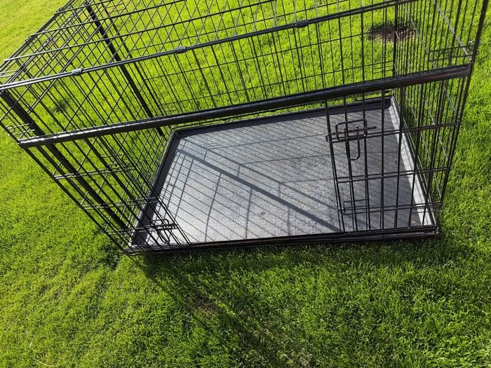 XL dog crate opens up by sliding doors at front and side. Read caption