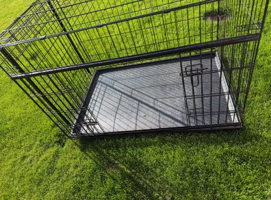 XL dog crate opens up by sliding doors at front and side. Read caption