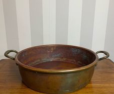 Beautiful large antique solid copper flat-bottom pan with riveted brass handles.