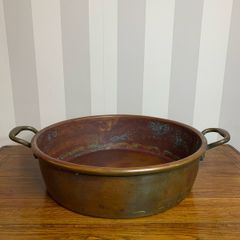 Beautiful large antique solid copper flat-bottom pan with riveted brass handles.