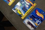 Hot Wheels Ferrari die-cast model cars from the mid-2000s and late 1990s card collections.