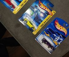 Hot Wheels Ferrari die-cast model cars from the mid-2000s and late 1990s card collections.
