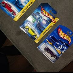 Hot Wheels Ferrari die-cast model cars from the mid-2000s and late 1990s card collections.