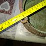 Antique Copper Cauldron features a Rustic Patina, a Swing Handle, and Distinctive Ribbed Detailing around the Rim. It resembles vintage metal pots often used for hearth decoration or as Planters. The piece shows significant oxidation and aging, characteri Image 7