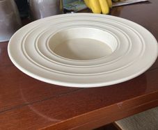 A vintage cream-colored dish Sombrero" design by Keith Murray for Wedgwood