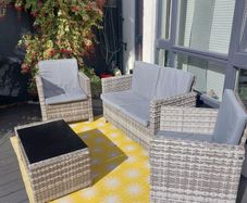 Rattan garden furniture: Sofa, 2 chairs and coffee table. 8 grey cushions, removable covers