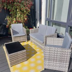 Rattan garden furniture: Sofa, 2 chairs and coffee table. 8 grey cushions, removable covers