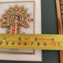 Framed in gelted frameThe painting of traditional Jewellery designs in Marble is done with gold leaf and colored glass. This art has its origin in the royal city of Jaipur  once a design is drawn on marble tile. the frame is 23 x20 cm. the center is 10 x  Image 2