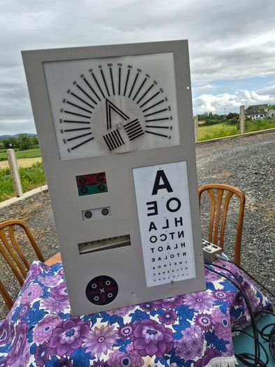 vintage optician's illuminated eye test chart, commonly used in the mid-20th century.