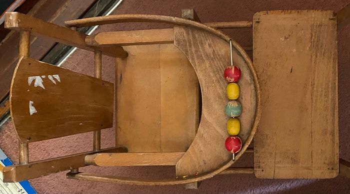 Vintage wooden doll high chair FROM THE 1930S featuring a built-in play tray with a wire bead