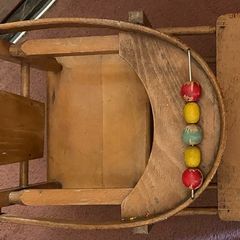 Vintage wooden doll high chair FROM THE 1930S featuring a built-in play tray with a wire bead