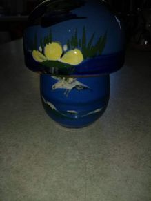 Blue cup and lid hand panted pottery.