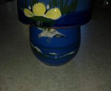 Blue cup and lid hand panted pottery.