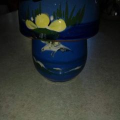 Blue cup and lid hand panted pottery.