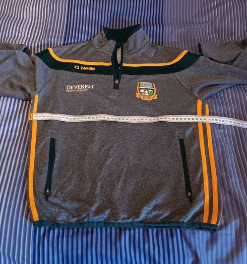 O'Neills Meath GAA Zip Top. Age 13. Width 47cm, Length 54cm. Very Good Condition. Price Includes Postage.