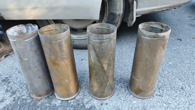 four empty brassartillery shell casings
