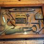 vintage shadow box containing a mix of antique tools, keys, and a loom. Image 2