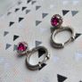A beautiful pair of  sterling silver hoop earrings featuring small encrusted zircons and a dazzling ruby pink halo pendant. Image 2