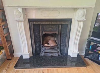 Castiron fireplace and surround plus marble mantlepiece and black stone heart